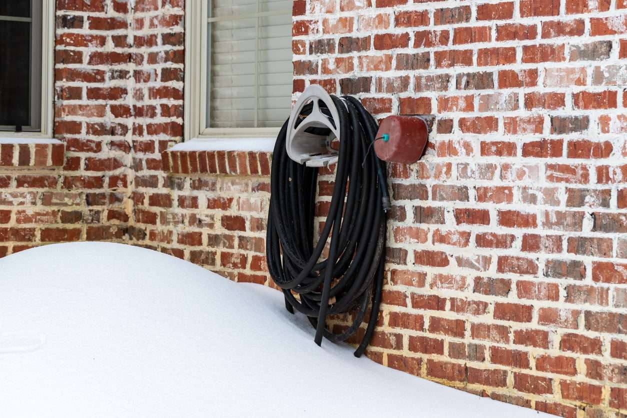 Faucet cover installed on water faucet to protect it from freezing temperatures
